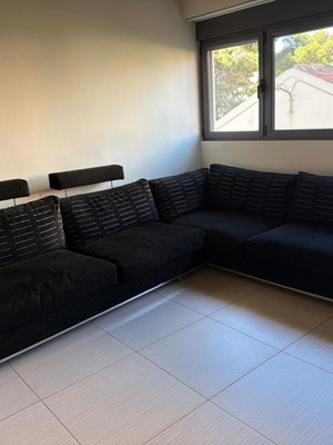 Corner sofa like new, black with silver details and feather cushions