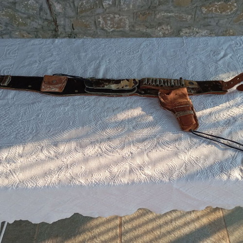 Vintage leather belt with cartridge and pistol holster used