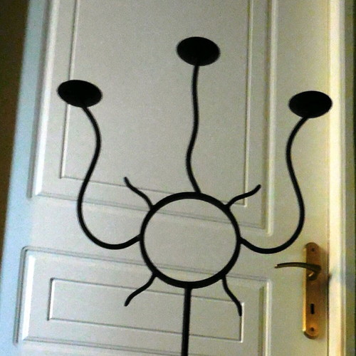 Metal floor candle holder like new with 3 bases, sun design
