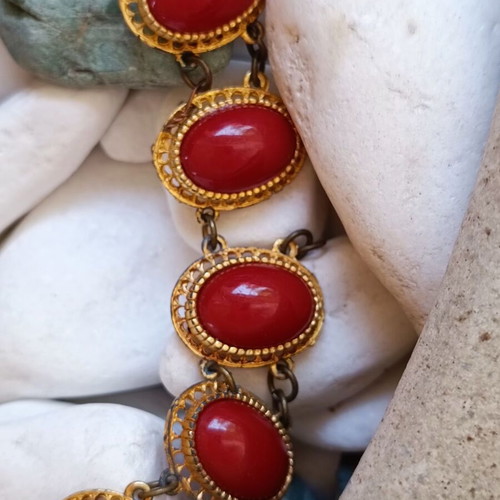 Vintage necklace used with red stones and brass metal
