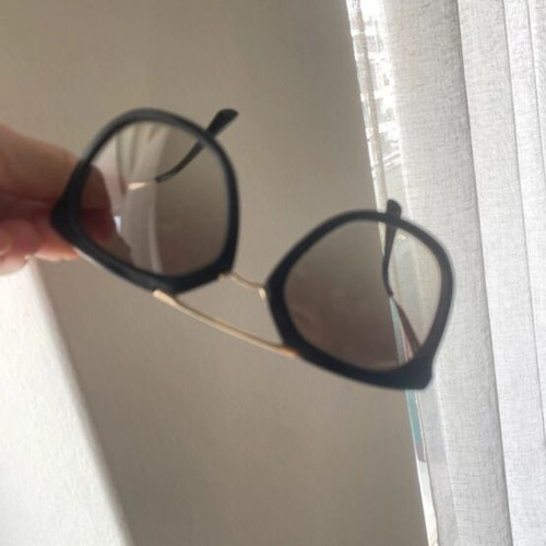 Prada sunglasses in black with gold details