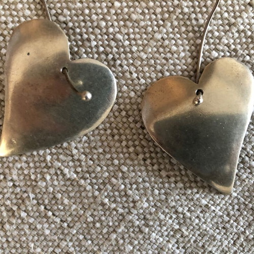 Silver earrings used in heart shape