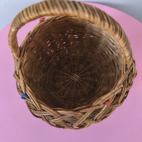 Handmade woven basket used with handle and decorative beads