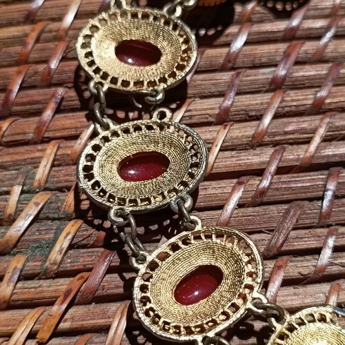 Vintage necklace used with red stones and brass metal