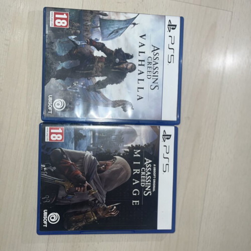 PlayStation 5 console used with two Assassin’s Creed games and DualSense controllers