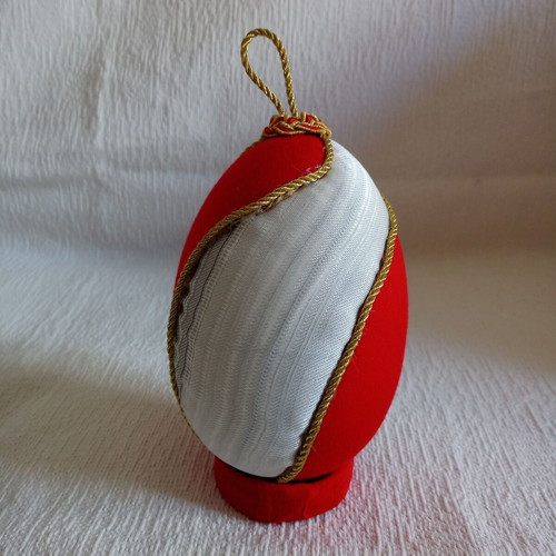 Decorative egg with spiral design used, red and gold