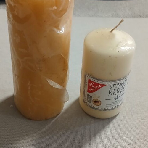 Set of 2 new candles, one with small dent
