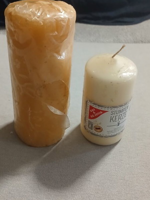 Set of 2 new candles, one with small dent