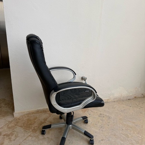 Office chair used with worn covers