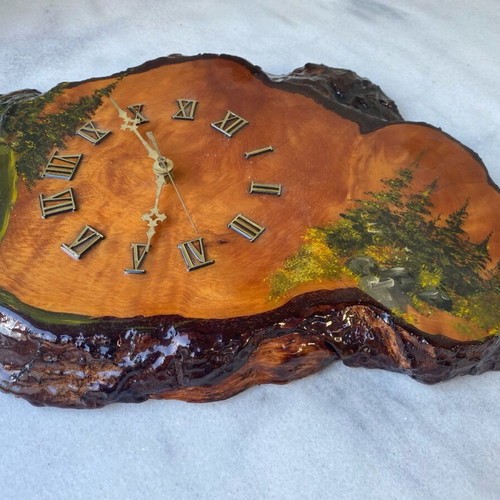 Handmade wooden wall clock from tree trunk.
