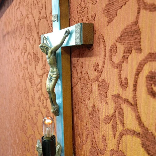 Old wooden crucifix used with bronze and light