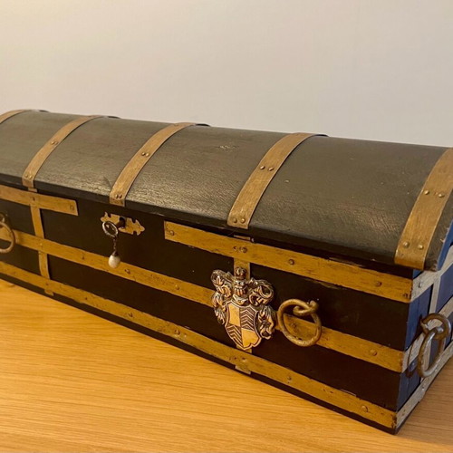 Antique wooden chest used with medieval emblem