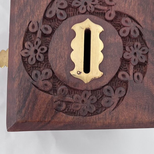 Wooden coin box with brass clip and carved design