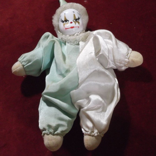 Porcelain clown doll used with white and green satin costume