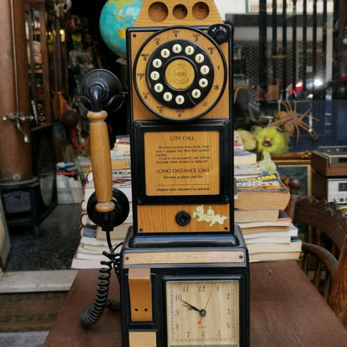 Vintage decorative wall telephone with clock used