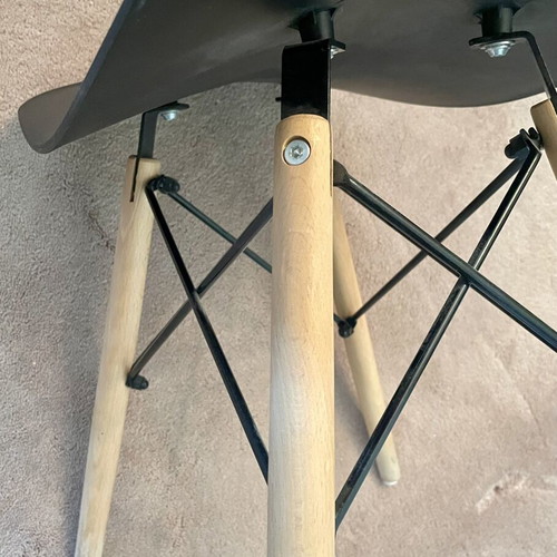 Low stool like new with black curved plastic seat and wooden legs
