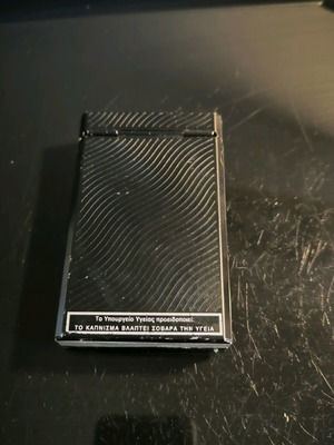 Metal cigarette case used with magnet closure