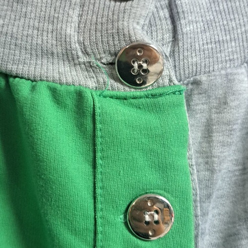 Two-tone sweatpants used, gray and green with metallic buttons, size XL