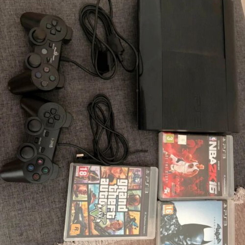 PlayStation 3 console with controllers and games