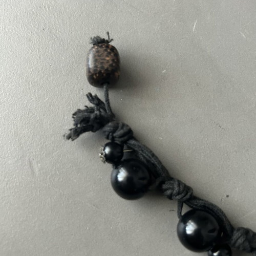 Black bracelet with beads and silver details like new, adjustable knot