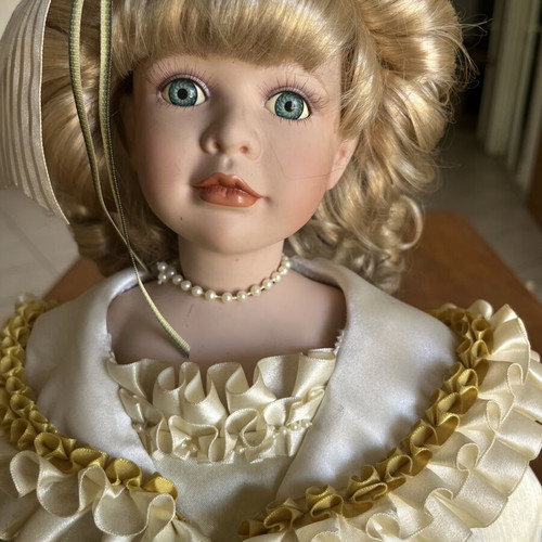 Porcelain doll sitting with curls, vintage