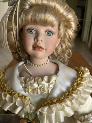 Porcelain doll sitting with curls, vintage
