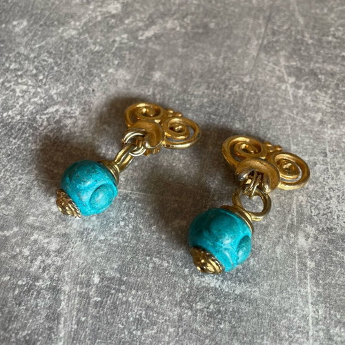 Dangling earrings used with turquoise and gold designs
