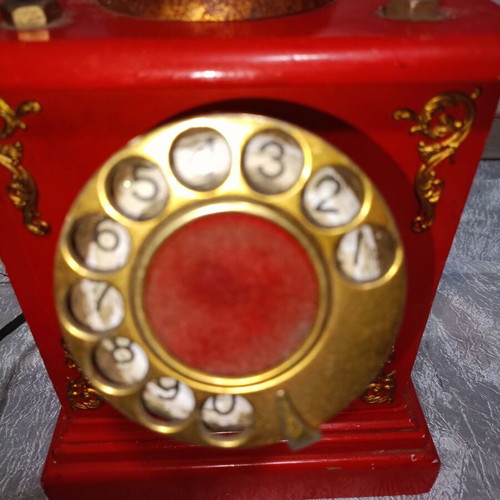 Vintage metal rotary phone, red with gold details