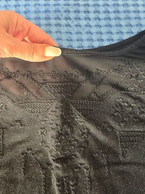 Black blouse with subtle chest design, size Large/Extra Large