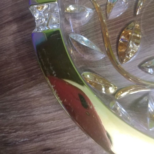 Crystal ashtray used, heavy with embossed gold-plated designs