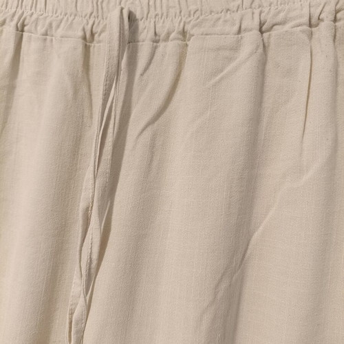 Women's loose beige pants with elastic waist and drawstring