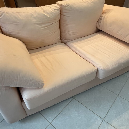 Fabric two-seater sofa used, light pink-peach with side cushions