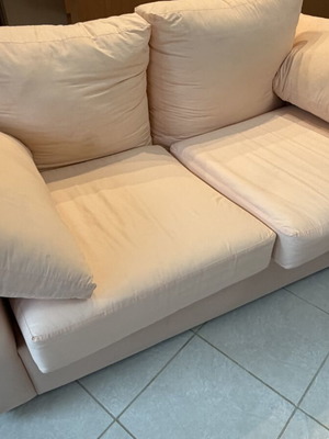Fabric two-seater sofa used, light pink-peach with side cushions