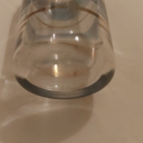 Vintage small glass bottle used with blue and gold stripes