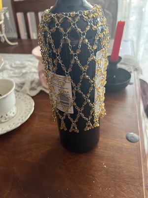 Decorative gold wine bottle cover with beads and chains like new