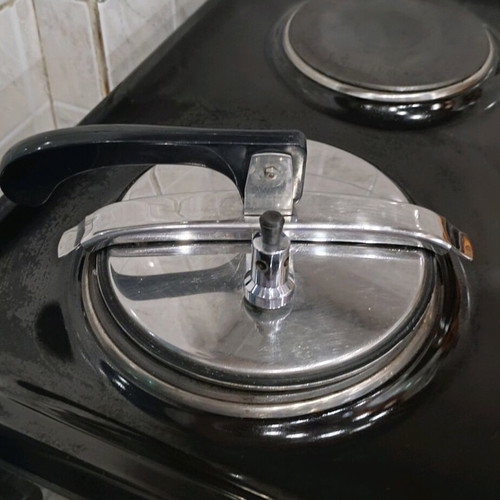 Pressure cooker used, old style, stainless steel with safety lid