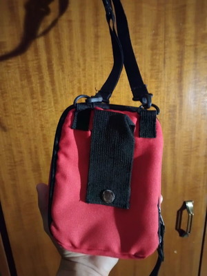 Small red shoulder bag used with multiple compartments