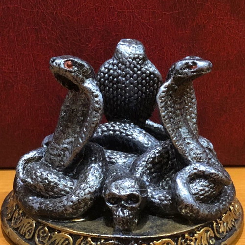Decorative figurine with snakes and skulls