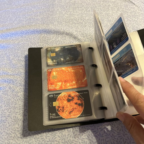 Phone card album with 32 universe-themed cards and 50 extra sleeves like new