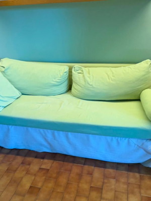 Three-seater sofa used, possibly Neoset, with new white throw