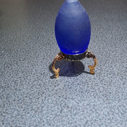 Vintage decorative crystal egg with blue matte glass and gold metal base used