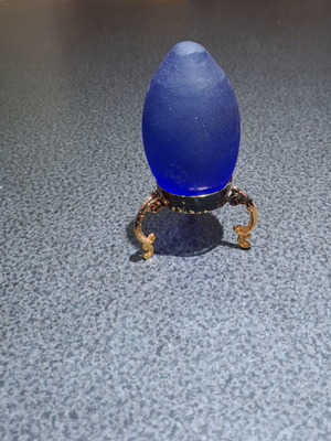 Vintage decorative crystal egg with blue matte glass and gold metal base used