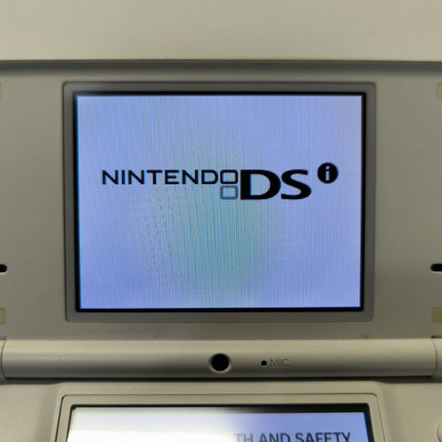 Nintendo DSi white console with 10 games and stylus used