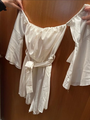 White mini shorts romper with loose sleeves and waist belt