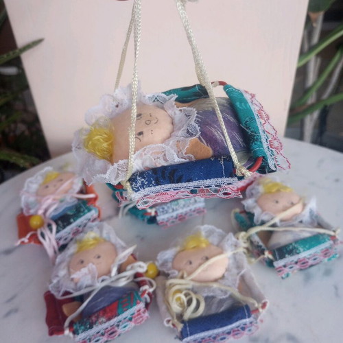 Seven cloth baby dolls in cradle new