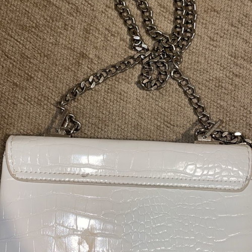 White crossbody bag used with silver details