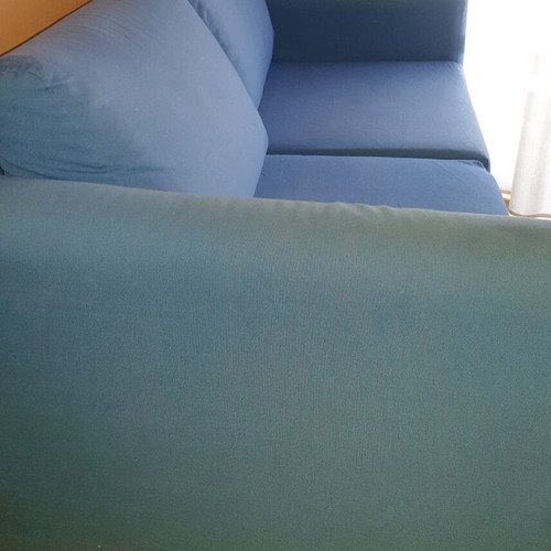 Two-seater sofa used without two back cushions