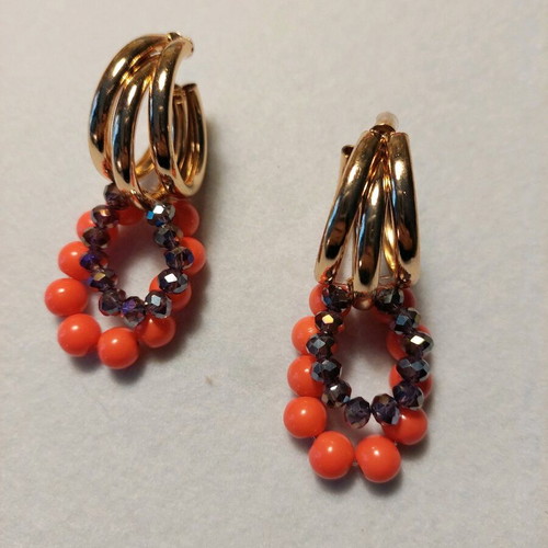 Handmade earrings with orange and purple beads on gold triple hoops
