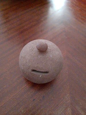 Handmade piggy bank used, made of sand