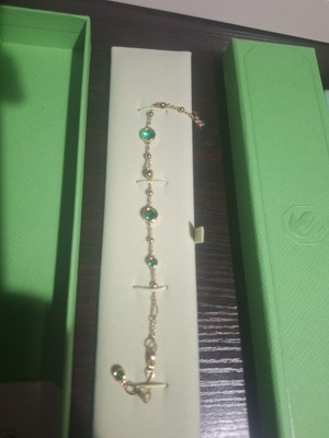 Swarovski bracelet with green stone and gold chain, like new